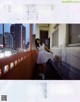 A woman in a white dress standing on a balcony.