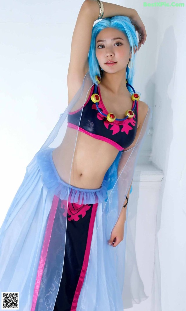 A woman with blue hair wearing a blue and pink outfit.