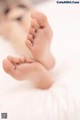 A close up of a baby's feet on a bed.